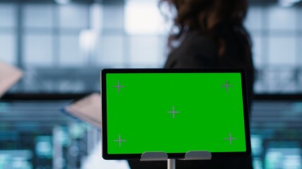 Close up of chroma key tablet next to server room data scientists conducting security audits,...