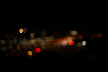 Bokeh lights of night city with dark background, shallow depth of field