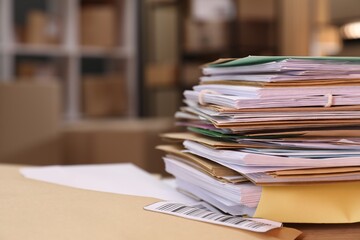Many different envelopes on table in post office. Space for text