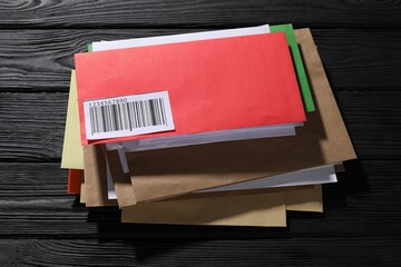 Different paper envelopes on black wooden table. Post office