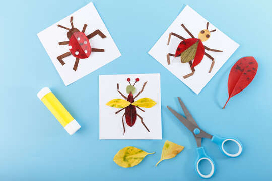 Handmade insect crafts using autumn leaves and paper on blue background. scissors, colorful leaves. Creative children activity for homeschooling, school projects, early childhood development