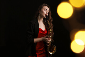 Professional musician playing saxophone on black background with blurred lights. Bokeh effect