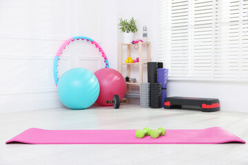 Many different fitness equipment and accessories indoors