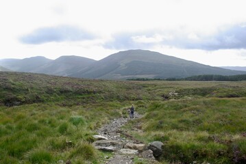 Girl walking in mountain landscape