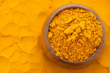 Organic turmeric powder in the bowl - Curcuma longa