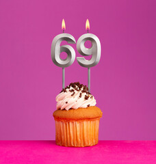 Birthday card on violet background - Candle number 69.