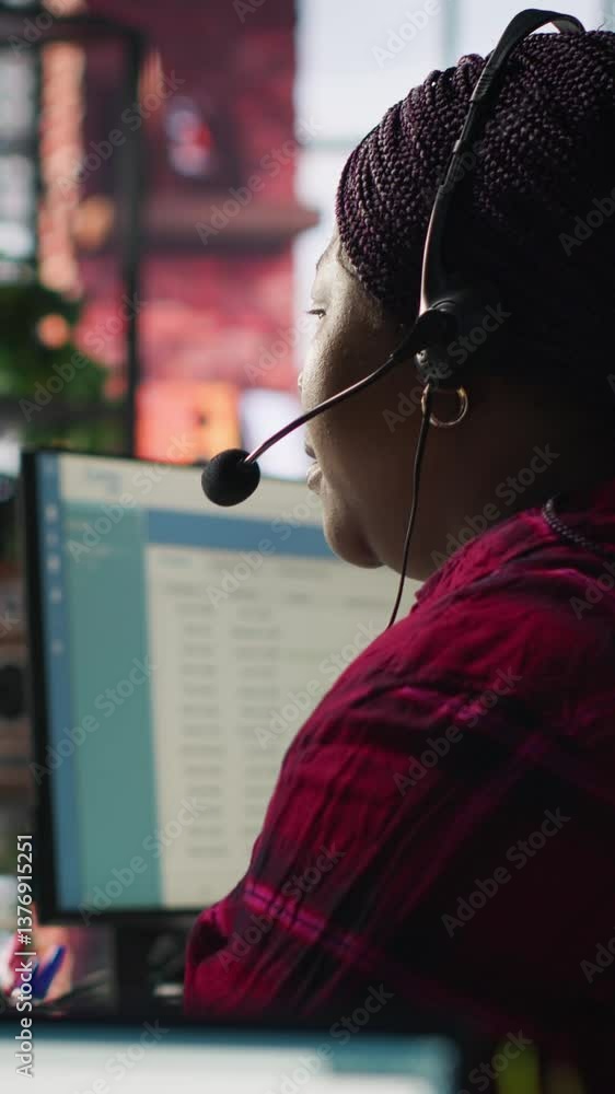Poster vertical video it support specialist at pc in office helping customers during call, troubleshooting 