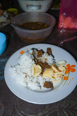 a plate of white rice and meat side dish