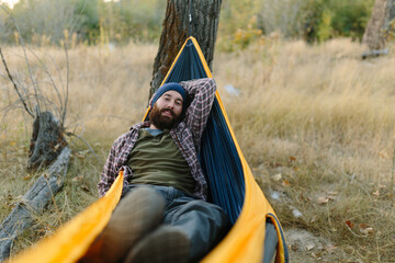 Handsome Outdoorsy Man Relaxing in Hammock