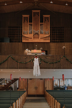 Wedding Dress Hanging in Church Balcony