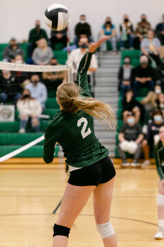 High School Girl Playing Volleyball on Court