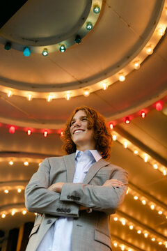 Teenager Standing under Movie Theater Lights