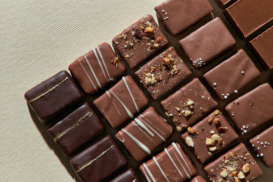 Naklejki Chocolate pralines in a row.