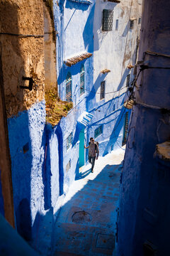 Man walking in an alley in the blue city