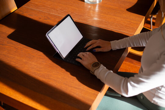 Woman working on tablet white screen