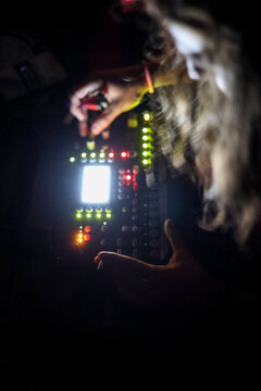 Blured image of long hair DJ holding lighter and cannabis cigarette