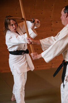 Woman and Man clash swords in Aikido