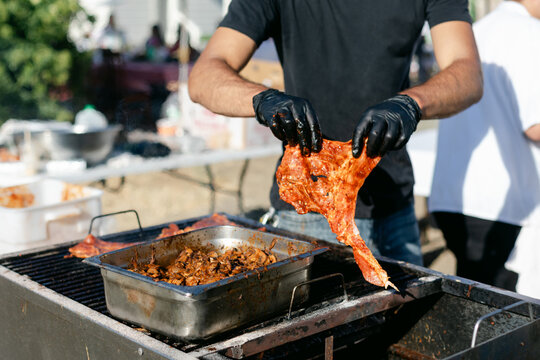 Man Cooking Meat on Outdoor Grill