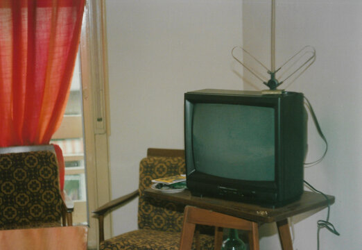 Old retro box tv. Old fashion tv on wooden table 