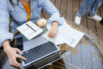 A woman works sitting outdoors