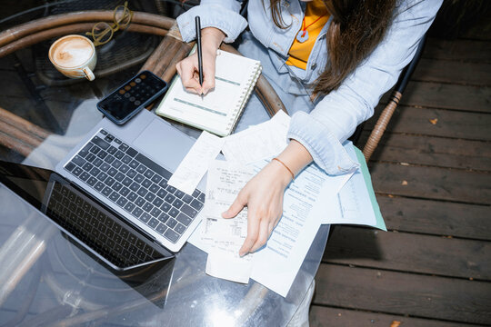 A woman works sitting outdoors