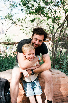 Father and Son hug outside the visitor's center at Zion National Park