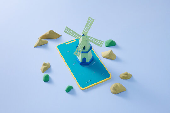 A digital windmill model displayed on a smartphone surrounded