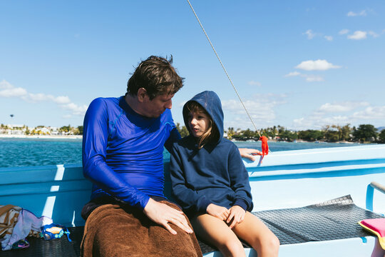 Father and daughter in the boat after snorkling