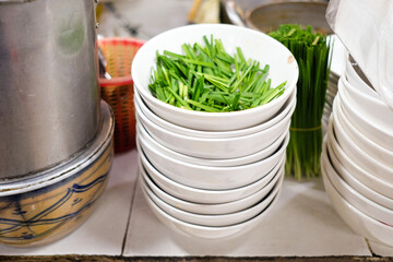 Stack of White Bowls with Fresh Greens