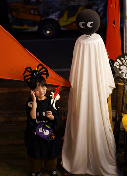Chinese boy dressed up as Halloween playing outdoors in the evening