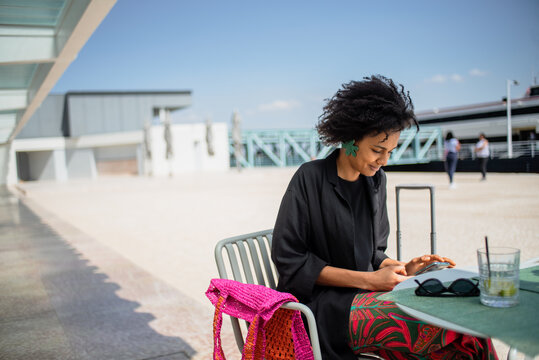 Lisbon woman at cafe by the river 