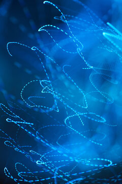 Vertical swirling light blurred blue background