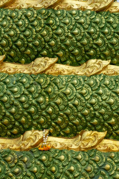 Close-up of a Naga Dragon Statue with Green and Gold Scales