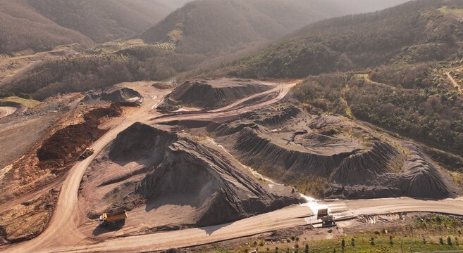 Aerial view of an open mining quarry and its surrounding landscape.