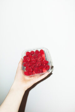 Juicy fresh sweet delicious red raspberries and hard direct flashlight
