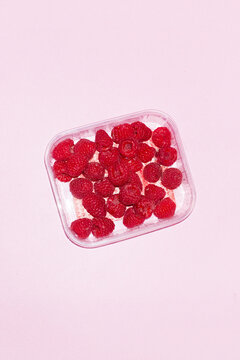 Juicy fresh sweet delicious red raspberries and hard direct flashlight