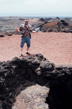 Tourist Exploring Volcanic Rocks in Lanzarote