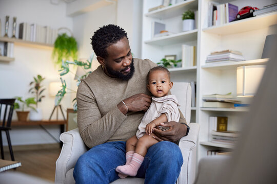 Dad fussing over baby