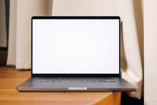 Mockup Laptop with White Screen on Wooden Surface
