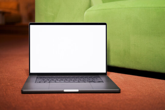 Laptop Display Mockup by Green Chair at modern office 