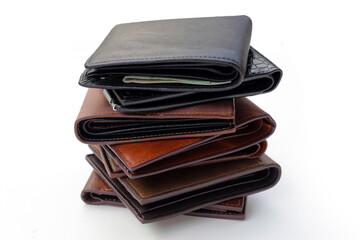 Stack of black and brown wallets on white background.