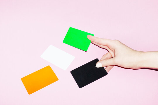Hand with colourful payment money bank credit cards with hard flash