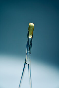 Surgical Forceps Holding a Gel Capsule