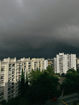 a dramatic clouds over a row of buildings