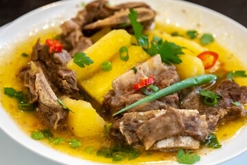 Traditional rustic Brazilian soup known as vaca atolada, prepared with cassava and beef ribs