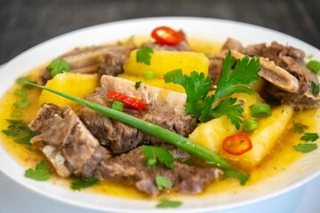 Traditional rustic Brazilian soup known as vaca atolada, prepared with cassava and beef ribs