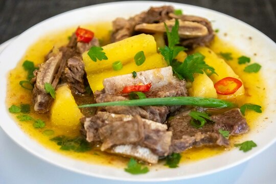 Traditional rustic Brazilian soup known as vaca atolada, prepared with cassava and beef ribs