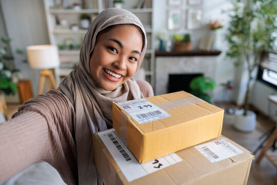 Woman's selfie with unopened boxes
