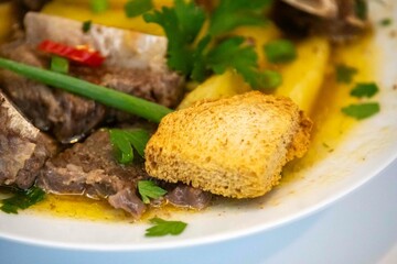 Traditional rustic Brazilian soup known as vaca atolada, prepared with cassava and beef ribs