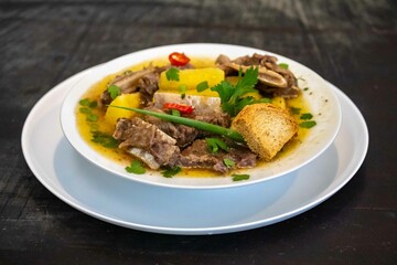 Traditional rustic Brazilian soup known as vaca atolada, prepared with cassava and beef ribs
